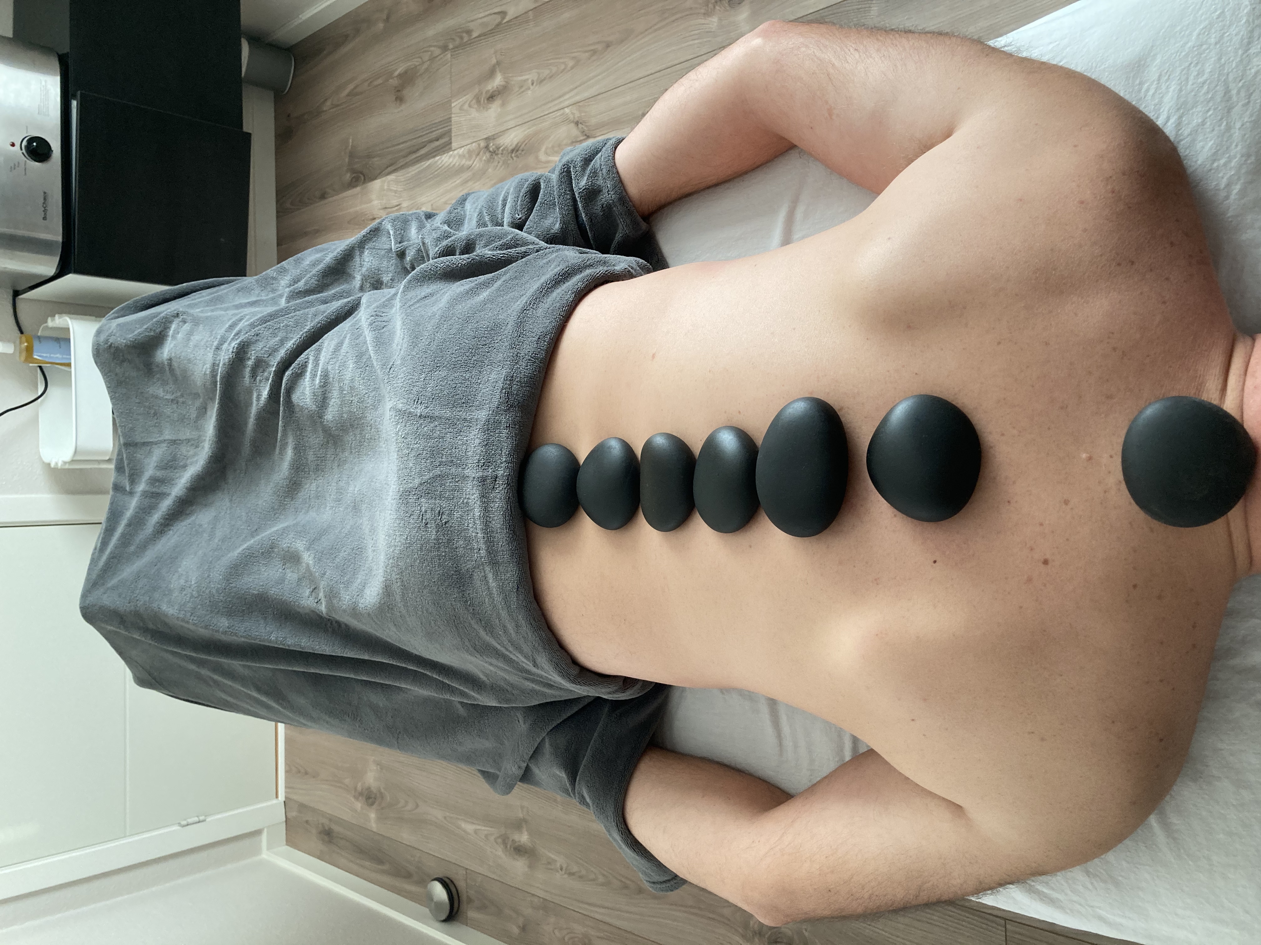 Man getting a massage with hotstone